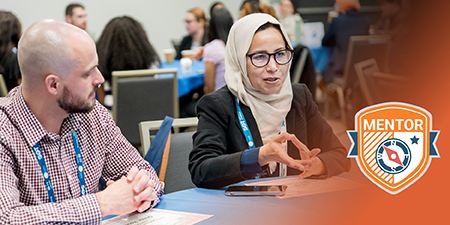 Two SOT Annual Meeting attendees participate in a small group discussion. 