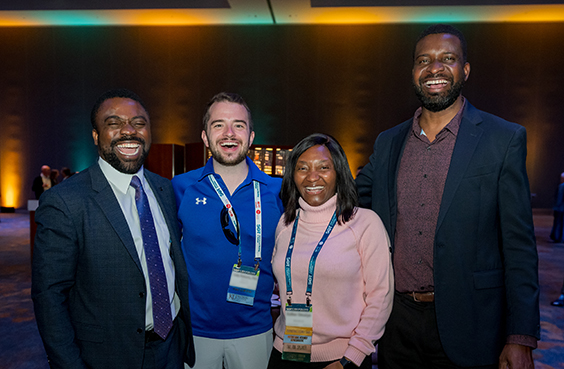 Four SOT Annual Meeting attendees smile together for a photo. 