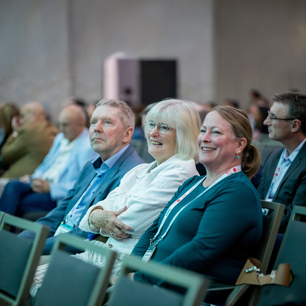 Conference attendees sit in a meeting room, smiling and listening during an SOT Annual Meeting session.