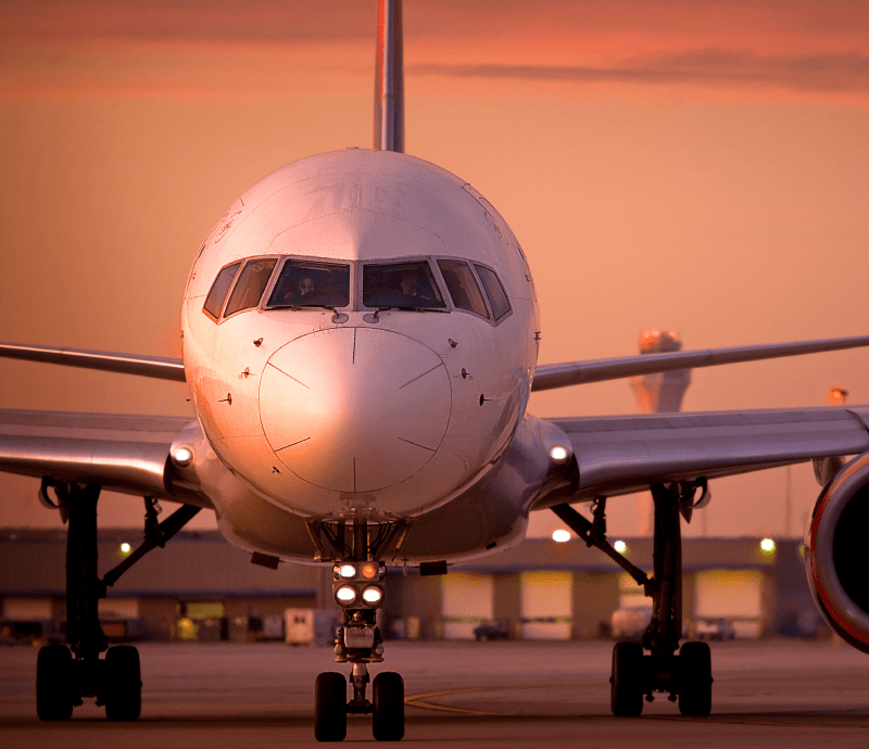 A street corner in downtown Orlando, Florida. There is a large vertical sign that says Orlando on the corner.